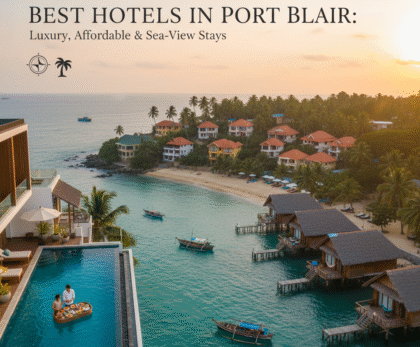 Best Hotels in Port Blair: An aerial view of a luxurious hotel with an infinity pool overlooking a stunning turquoise bay with overwater bungalows and traditional boats